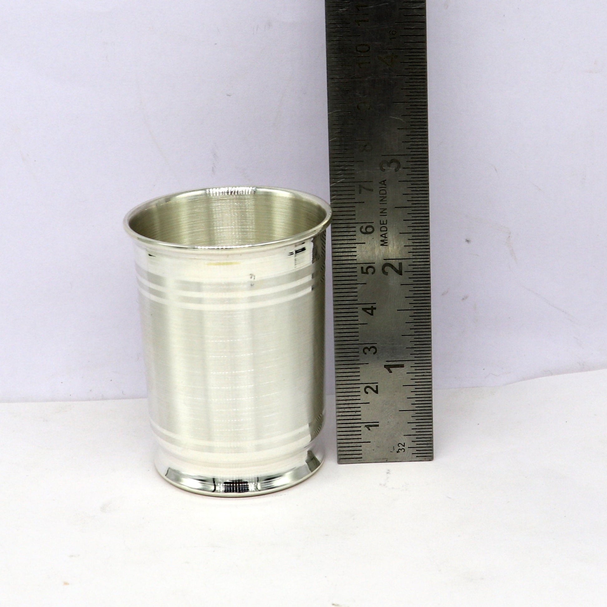 Handmade 999 fine silver water and milk glass tumbler, silver flask, and baby silver utensils from Tribal Ornaments.