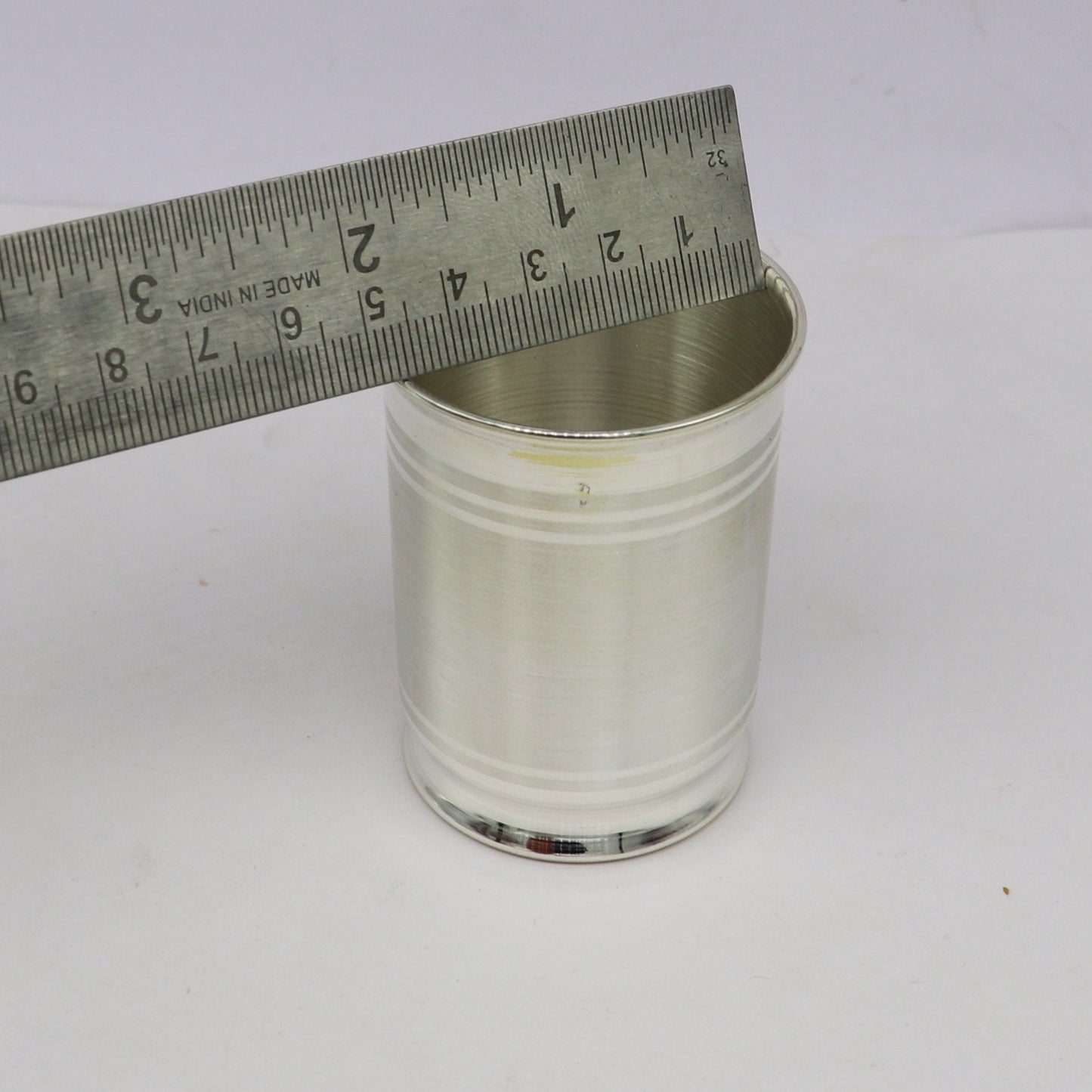 Handmade 999 fine silver water and milk glass tumbler, baby silver utensils, and silver flask by TRIBAL ORNAMENTS.