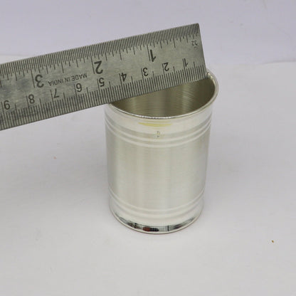 Handmade 999 fine silver water and milk glass tumbler, baby silver utensils, and silver flask by TRIBAL ORNAMENTS.