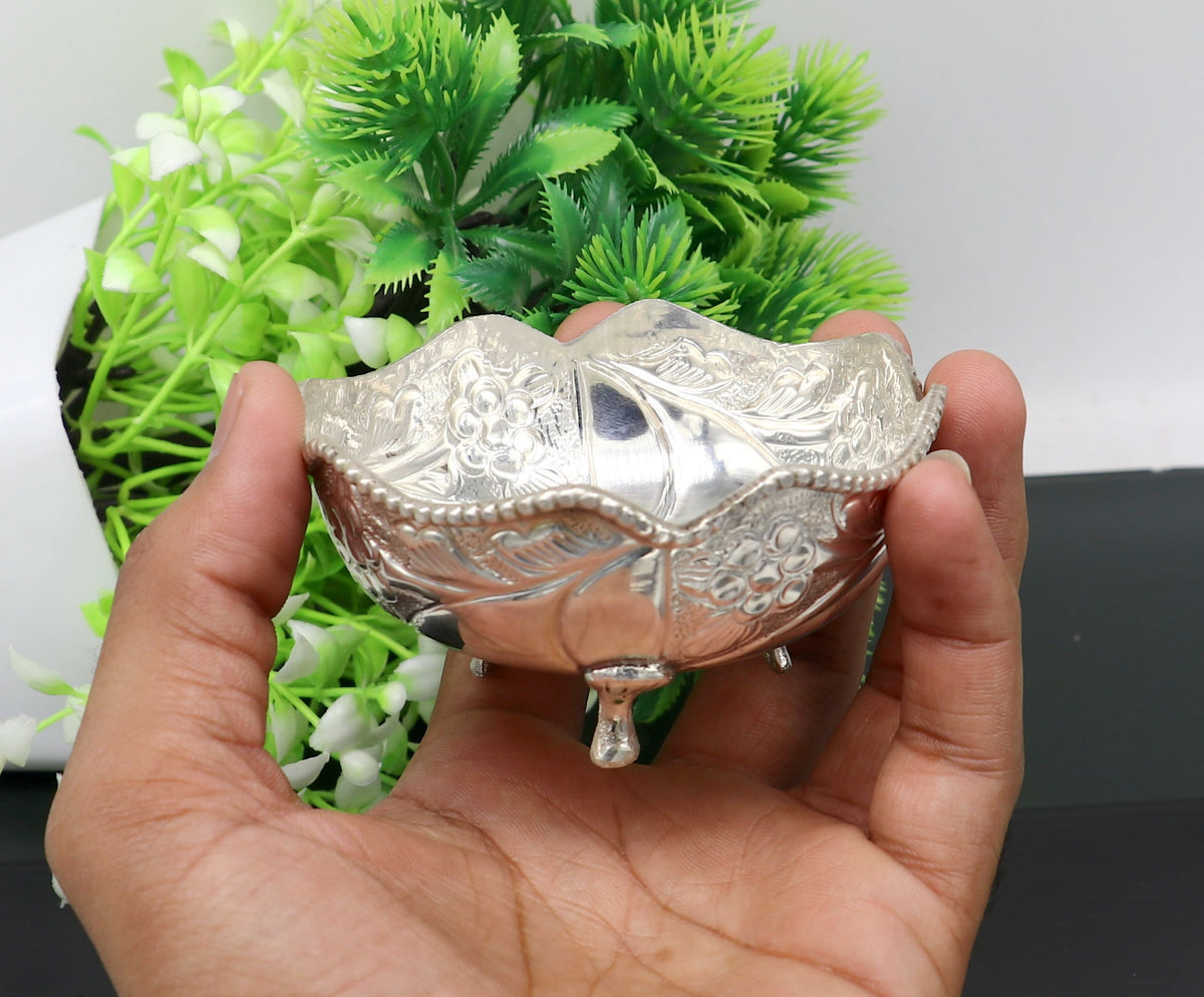 Vintage 999 fine silver worshipping puja bowl with intricate design, used for prasadam and idols like Krishna in religious rituals.