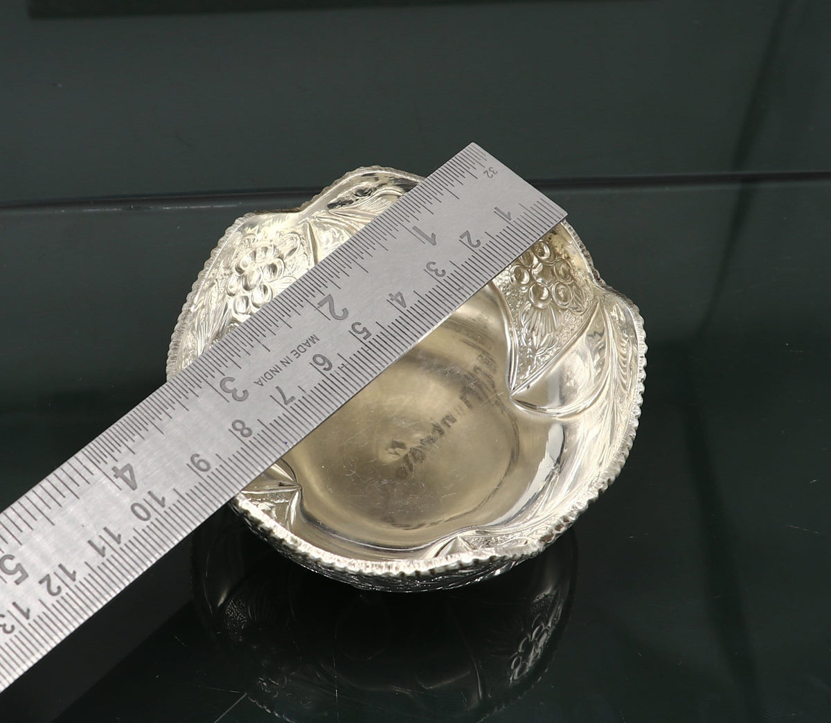 Silver vintage-style worshipping puja bowl with detailed design, used for prasadam offerings in Hindu rituals.