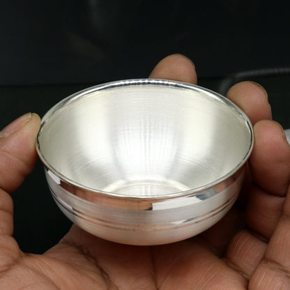 Handmade 999 fine solid silver bowl from TRIBAL ORNAMENTS, suitable as a baby gift or puja utensil, with intricate silver craftsmanship.