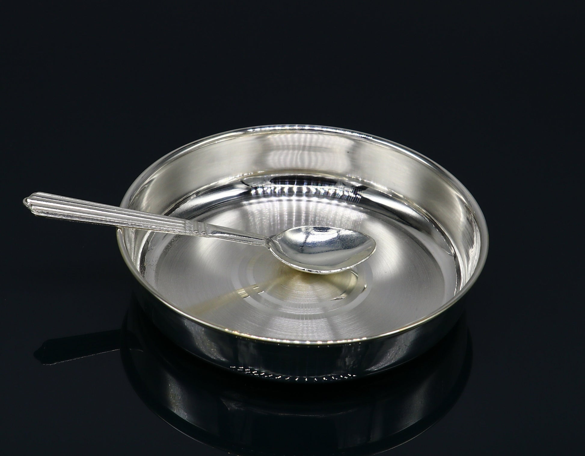 Solid silver handmade tray for baby food serving, ideal for rice ceremony, with intricate tribal design by TRIBAL ORNAMENTS.
