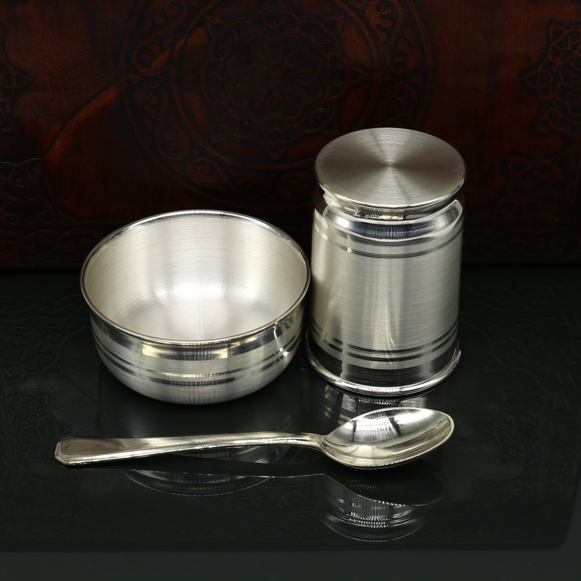 Pure silver combo bowl and water tumbler set by Tribal Ornaments, featuring silver baby utensils and kid’s food vessels.