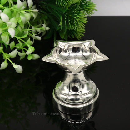 Elegant handmade 999 pure silver oil lamp, ideal for home temple puja, with intricate silver diya and vessels by TRIBAL ORNAMENTS