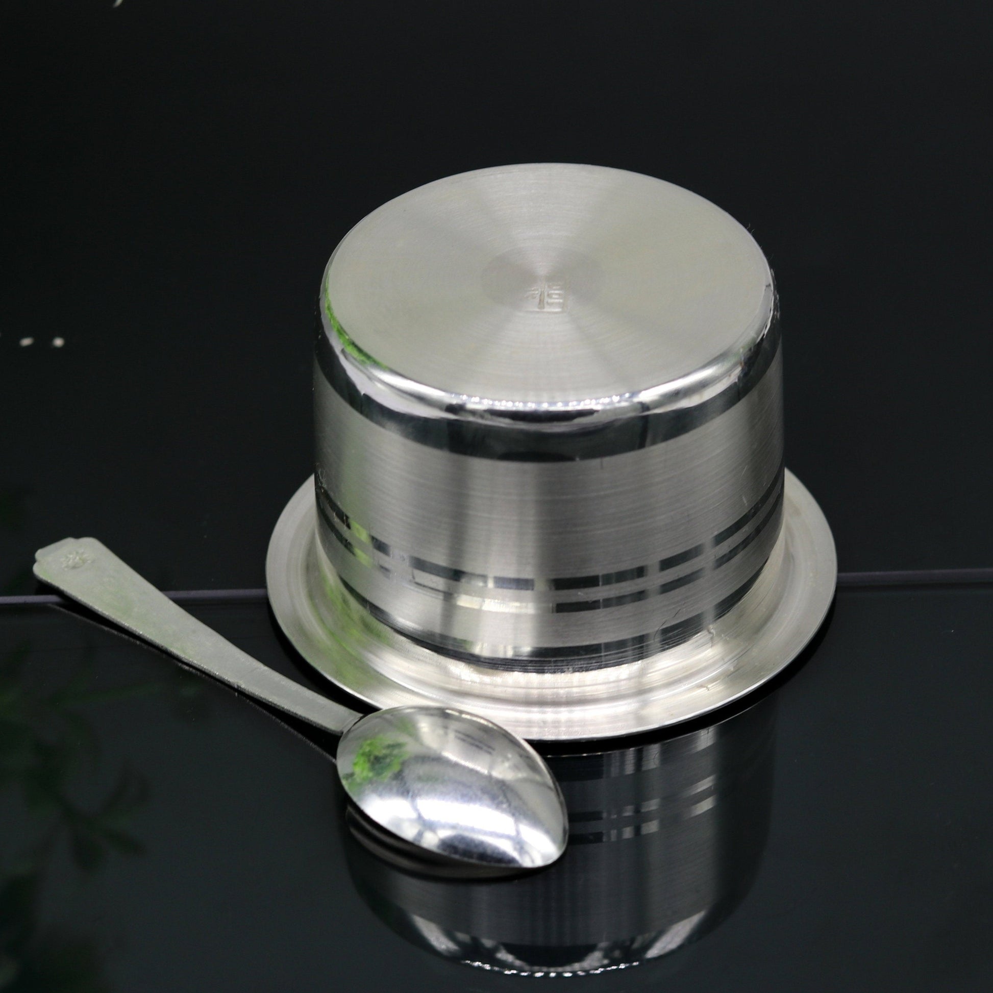 Handmade 999 pure silver baby feeding set with bowl and spoon, featuring traditional tribal ornament design and solid silver vessels.