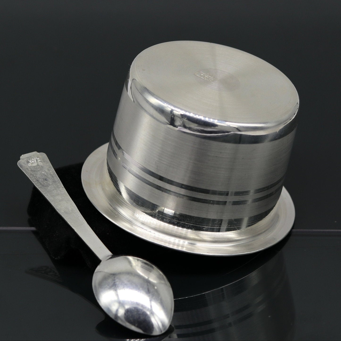 Handmade 999 pure silver baby feeding set with bowl and spoon from TRIBAL ORNAMENTS, featuring a tumbler and silver utensils.