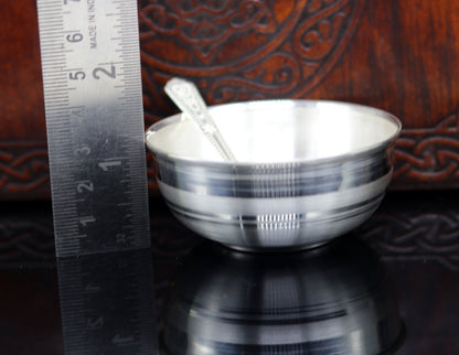Handmade 999 pure sterling silver baby serving bowl and spoon set by TRIBAL ORNAMENTS, featuring elegant silver vessels and utensils.