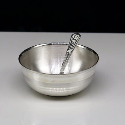 Handmade 999 pure sterling silver baby serving bowl and spoon set by TRIBAL ORNAMENTS, featuring sleek silver vessels and utensils.