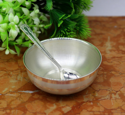 Handmade 999 pure sterling silver bowl and spoon by TRIBAL ORNAMENTS, showcasing sleek, antibacterial silver vessels for healthy living.