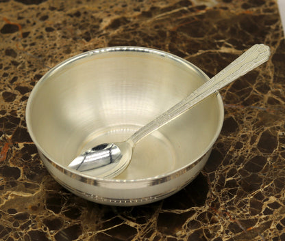 Handmade 999 pure sterling silver bowl and spoon by TRIBAL ORNAMENTS, showcasing polished silver with antibacterial properties.