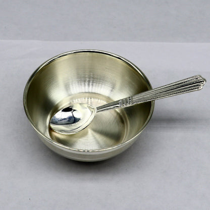 Handmade 999 pure sterling silver bowl and spoon set for baby feeding, featuring a sleek silver vessel and utensils.