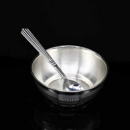 Handmade 999 pure sterling silver baby bowl and spoon set, featuring a sleek silver vessel for healthy food serving.