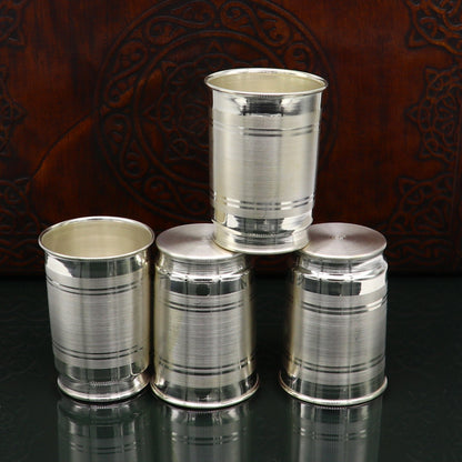 Handmade 999 silver baby glass set with tumblers for water and milk, featuring elegant design and versatile feeding utensils.