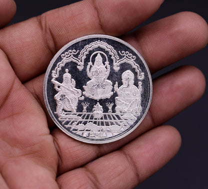 999 solid silver Indian idol coin featuring Lord Ganesha, Laxmi, and Saraswati print, 20 grams, collectible and gift-ready from Tribal Ornaments.