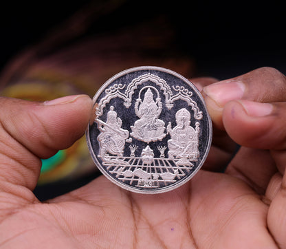 999 solid silver Indian idol coin featuring Lord Ganesha, Laxmi, and Saraswati print, 20 grams, collectible and ideal for gifting.