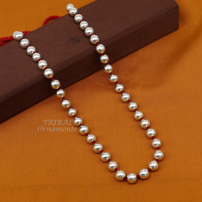 Sterling silver 9mm beaded tribal necklace by TRIBAL ORNAMENTS, showcasing colorful wax beads and cultural jewelry design.