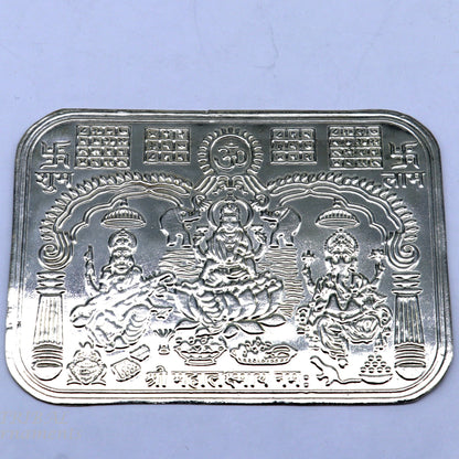 Handmade 9x6.3 cm sterling silver Shree Lakshmi frame featuring Ganesha and Saraswati, symbolizing wealth and prosperity.