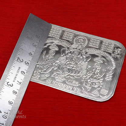 Handmade 9x6.3 cm sterling silver Shree Lakshmi, Ganesha, and Saraswati divine frame for wealth and prosperity.