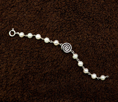 Sterling silver handmade baby bracelet with white pearl beads, crafted by Tribal Ornaments, perfect for kids jewelry.