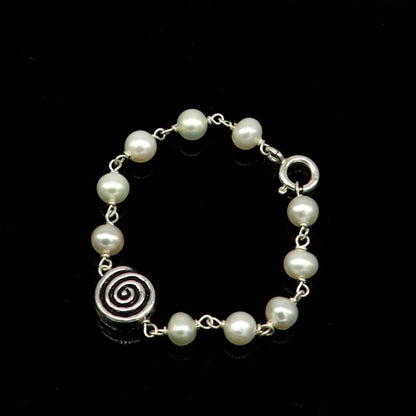 Sterling silver handmade baby bracelet with white pearl beads, crafted by TRIBAL ORNAMENTS, perfect for kids jewelry.