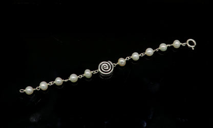 Sterling silver handmade baby bracelet with natural white pearl beads, ideal for kids jewelry by TRIBAL ORNAMENTS.