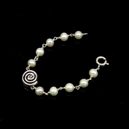 Handmade 925 sterling silver baby bracelet with natural white pearl beads, perfect for kids' jewelry by Tribal Ornaments.
