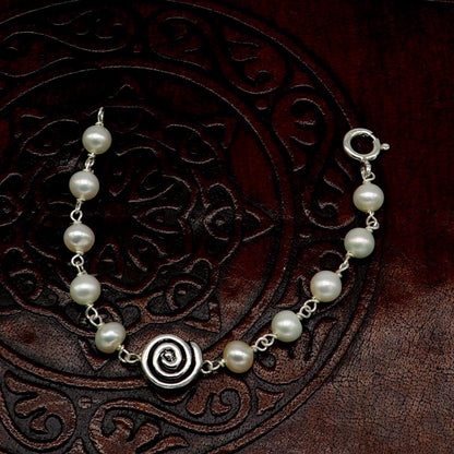 Sterling silver handmade baby bracelet with white pearl beads, crafted by TRIBAL ORNAMENTS, ideal for kids jewelry.