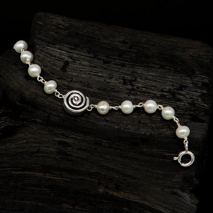 Sterling silver handmade baby bracelet with natural white pearl beads, perfect for kids jewelry by TRIBAL ORNAMENTS.