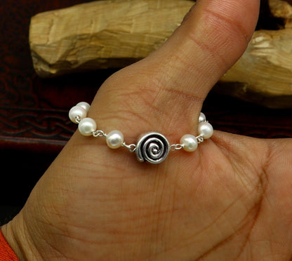 Sterling silver handmade baby bracelet with natural white pearl beads, created by TRIBAL ORNAMENTS, perfect for kids jewelry.