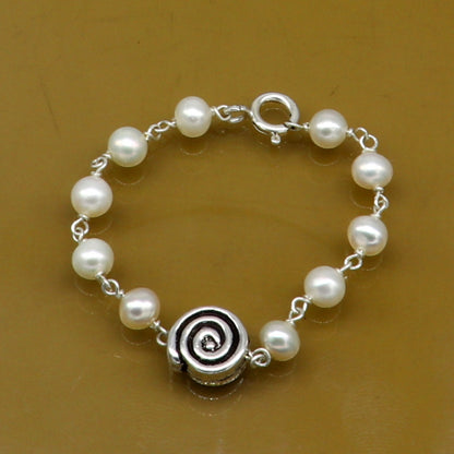 Sterling silver handmade baby bracelet with natural white pearl beads, crafted by TRIBAL ORNAMENTS for kids jewelry.