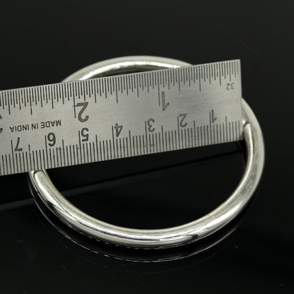Bright shining 925 sterling silver unisex round bangle bracelet from TRIBAL ORNAMENTS, showcasing intricate handmade jewelry design.
