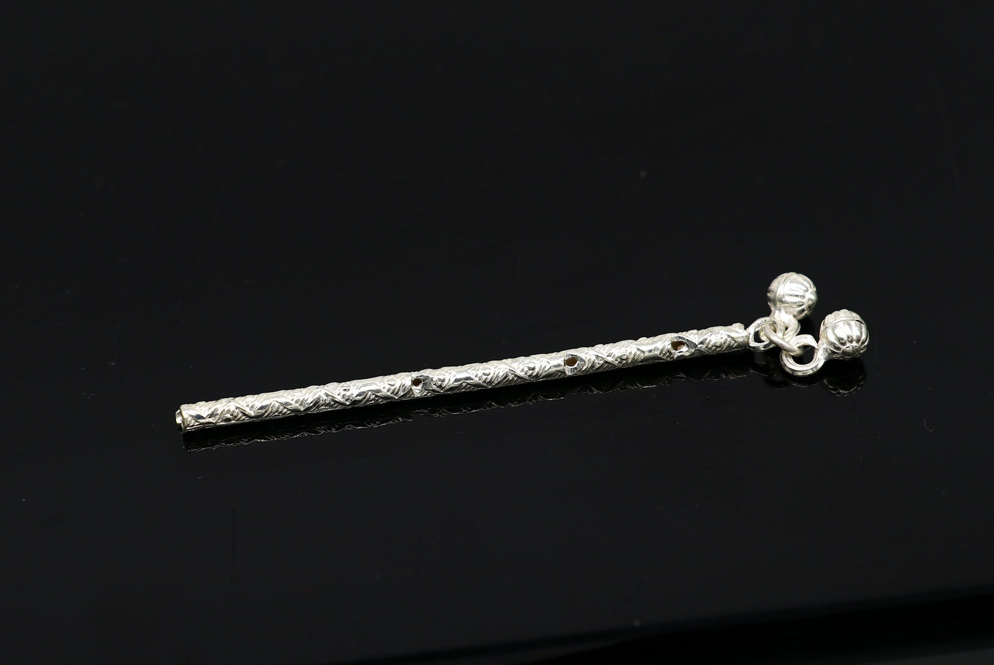 Handmade sterling silver Krishna flute idol with detailed design, featuring a small Krishna figure and traditional bansuri for puja.