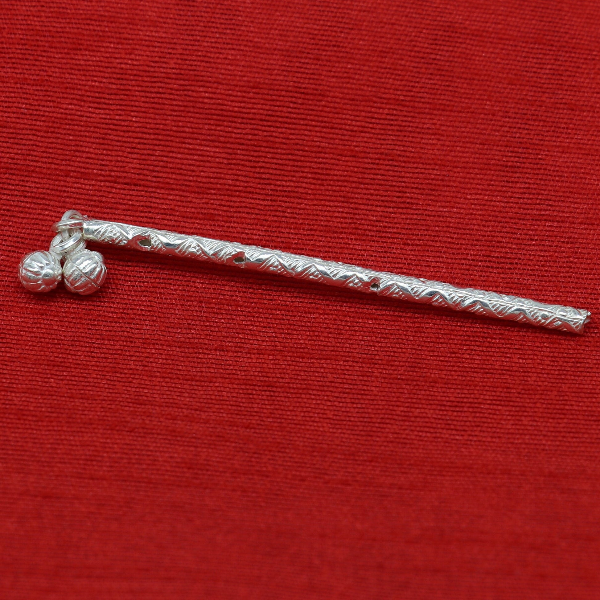 Handmade sterling silver Krishna flute idol with intricate design, featuring a silver bansuri and traditional puja art details.