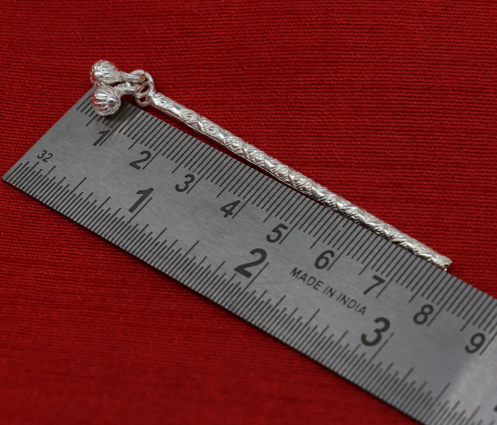 Sterling silver handmade Krishna flute idol with intricate design, featuring a traditional bansuri and puja art details.