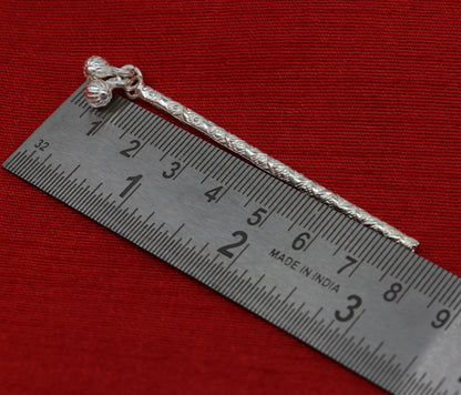 Handmade sterling silver Krishna flute idol, detailed puja art with intricate design, crafted by TRIBAL ORNAMENTS.