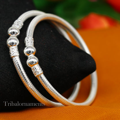 Sterling silver bangle bracelet with tribal-inspired design by TRIBAL ORNAMENTS, featuring customized craftsmanship and intricate detailing.