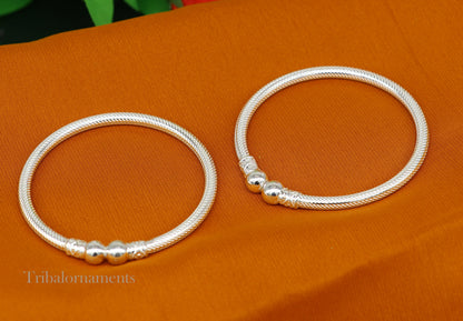 Sterling silver bangle bracelet by TRIBAL ORNAMENTS featuring a customized tribal design and intricate craftsmanship.
