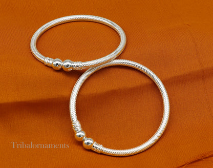 Sterling silver bangle bracelet with tribal design from TRIBAL ORNAMENTS, customized jewelry featuring intricate patterns and craftsmanship.