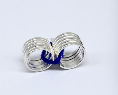 Pair of handmade solid silver toe rings with spiral design, tribal, boho, and belly dance jewelry by TRIBAL ORNAMENTS.