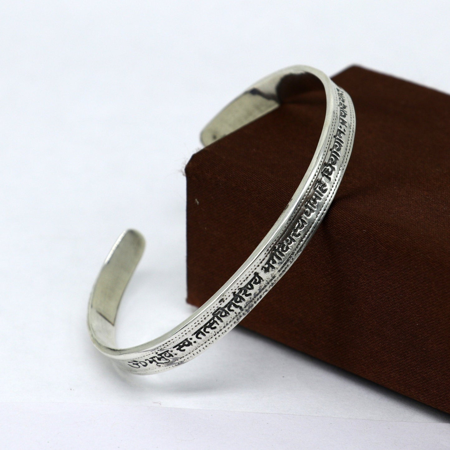 Sterling silver Gayatri Mantra cuff bracelet by Tribal Ornaments, unisex jewelry with adjustable design and intricate mantra detailing.