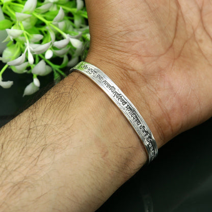Sterling silver Gayatri Mantra cuff bracelet by TRIBAL ORNAMENTS, unisex jewelry with adjustable design and intricate mantra engraving.