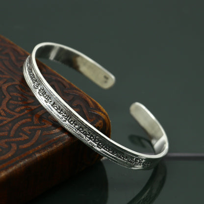 Sterling silver Gayatri Mantra cuff bracelet by TRIBAL ORNAMENTS, unisex jewelry with adjustable design and engraved mantra detail.