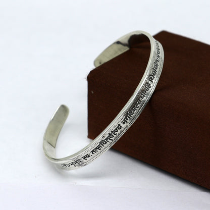 Sterling silver Gayatri Mantra cuff bracelet by TRIBAL ORNAMENTS, unisex jewelry with adjustable fit and intricate engraved design.