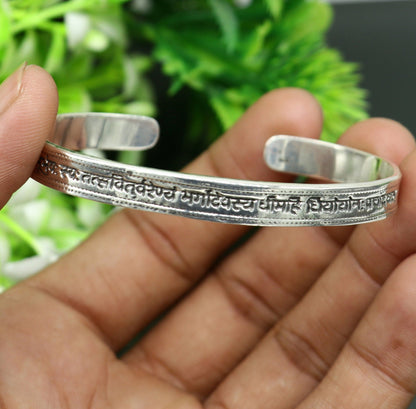 Sterling silver Gayatri Mantra cuff bracelet by TRIBAL ORNAMENTS, unisex jewelry with adjustable fit and engraved mantra design.