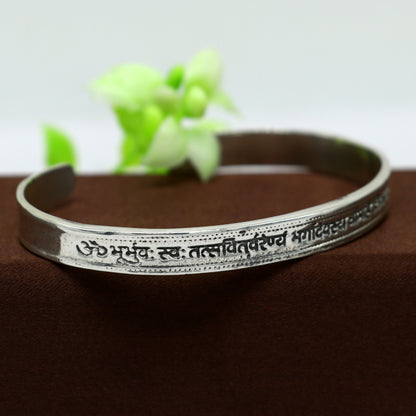 Sterling silver Gayatri Mantra cuff bracelet by TRIBAL ORNAMENTS, unisex jewelry with adjustable design and intricate mantra engraving.