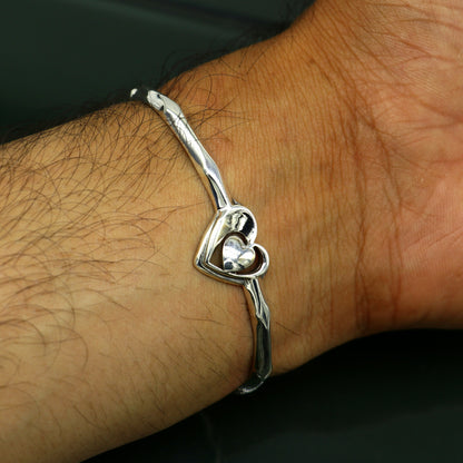 Sterling silver heart design cuff bracelet by TRIBAL ORNAMENTS, adjustable handmade jewelry with elegant silver craftsmanship.