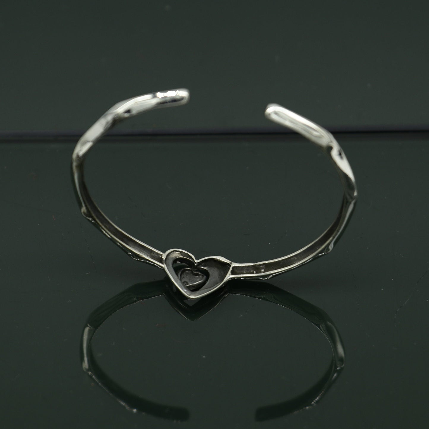 Sterling silver heart design bangle cuff bracelet by Tribal Ornaments, adjustable handmade jewelry with intricate heart details.