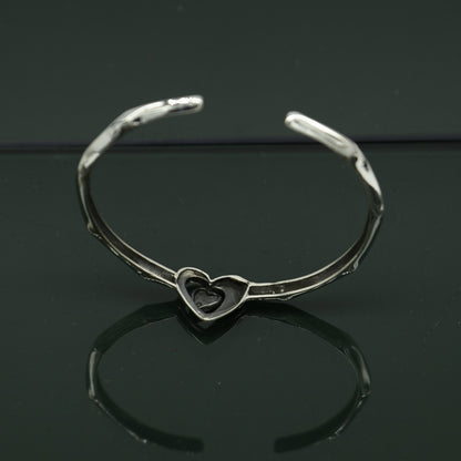 Sterling silver heart design bangle cuff bracelet by Tribal Ornaments, adjustable handmade jewelry with intricate heart details.