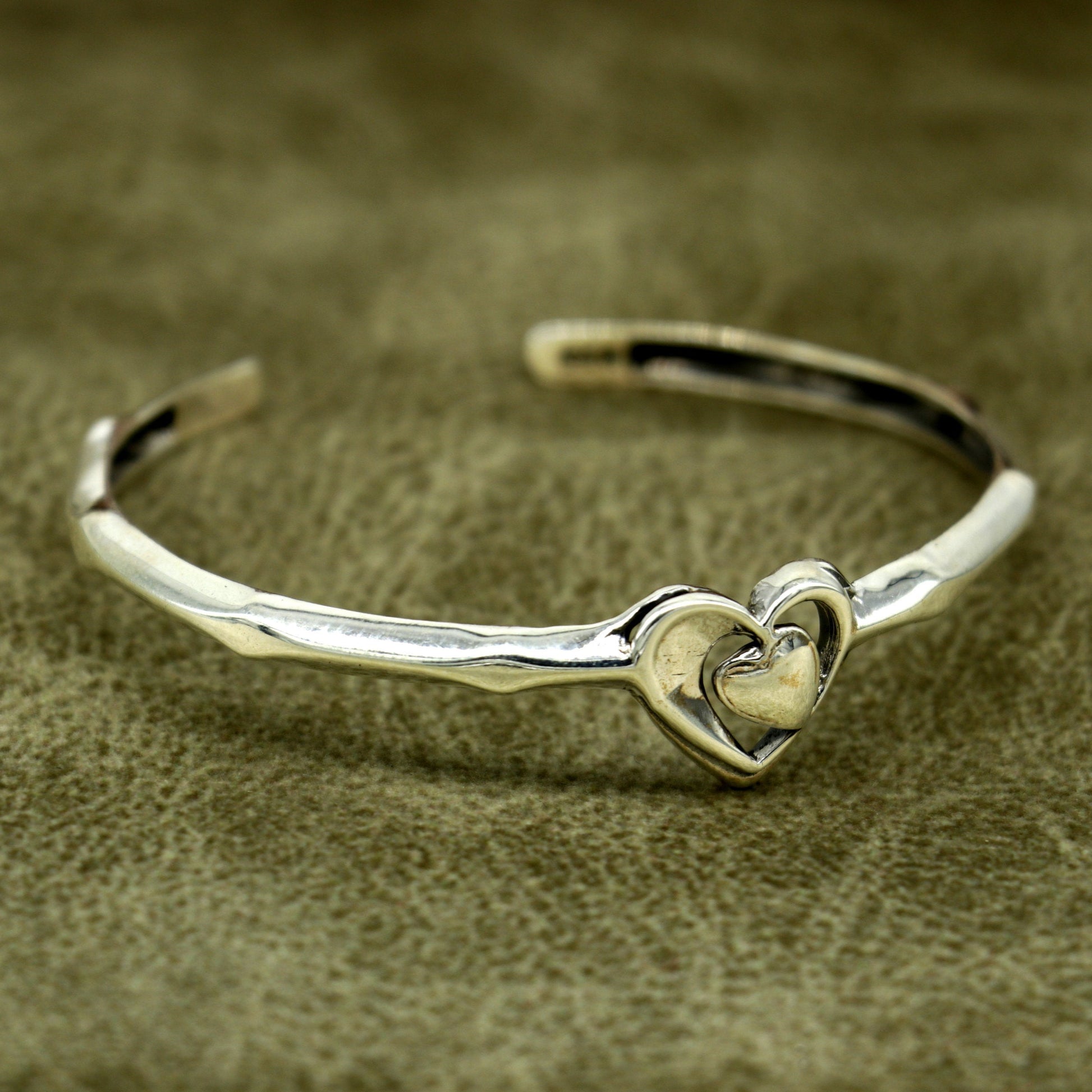 925 sterling silver heart design bangle bracelet by TRIBAL ORNAMENTS, featuring a handmade, adjustable cuff with an elegant heart motif.